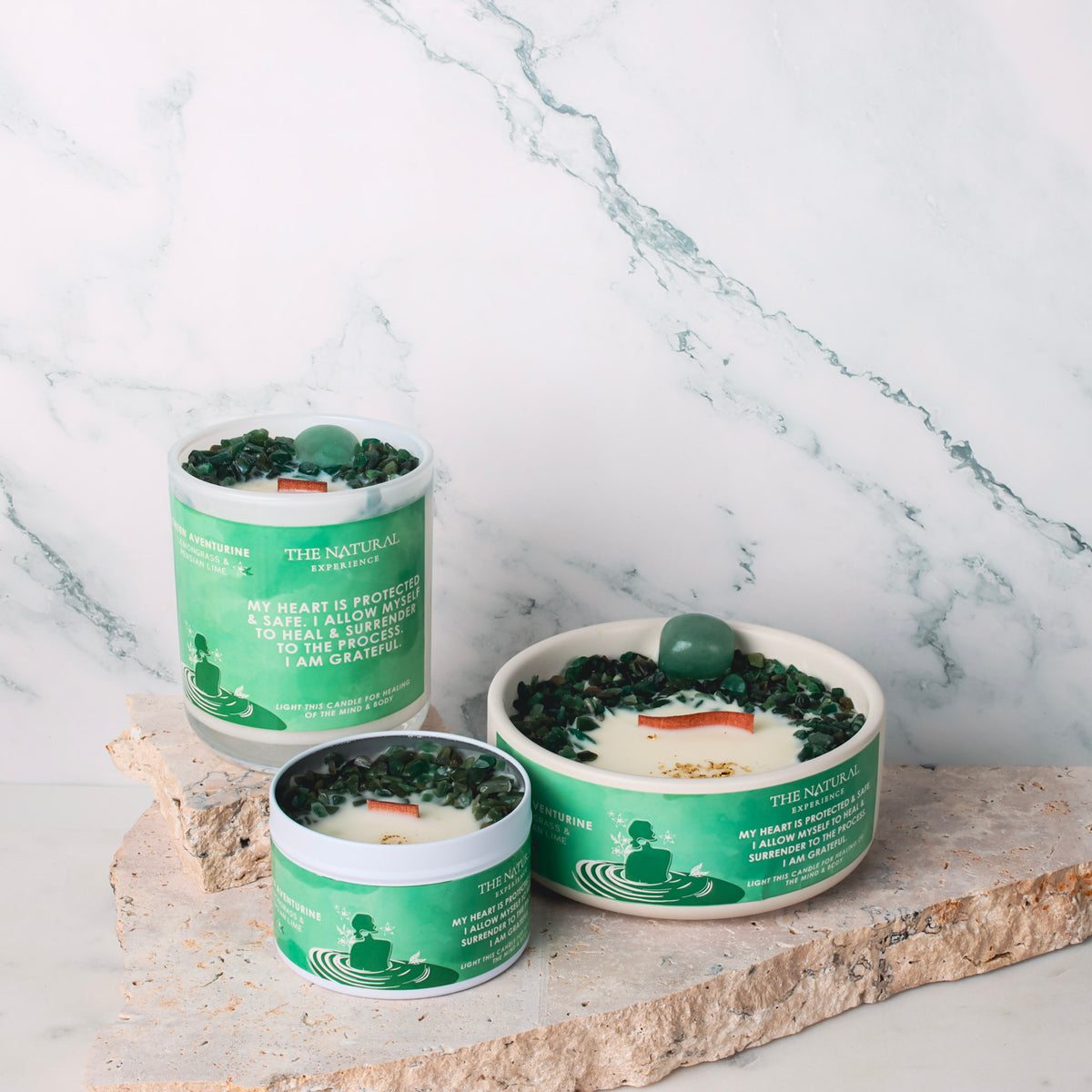 A Green Aventurine crystal candle emitting a warm glow, surrounded by fresh lemongrass and Persian lime, creating a serene and uplifting atmosphere