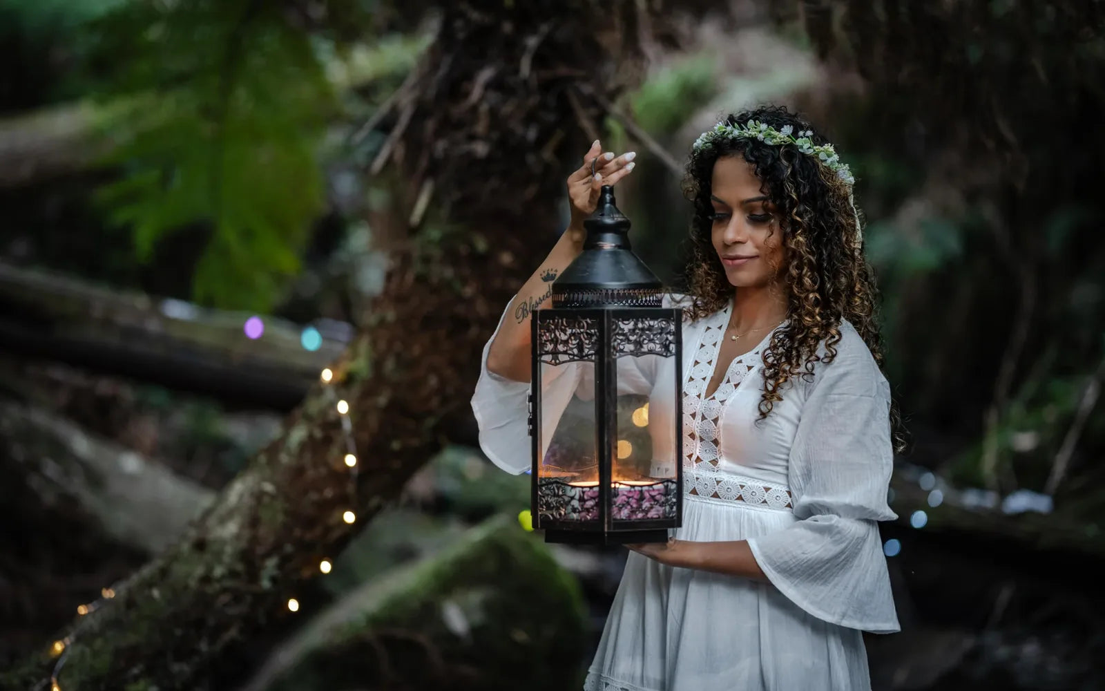 Woman holding a glowing lantern in a natural outdoor setting